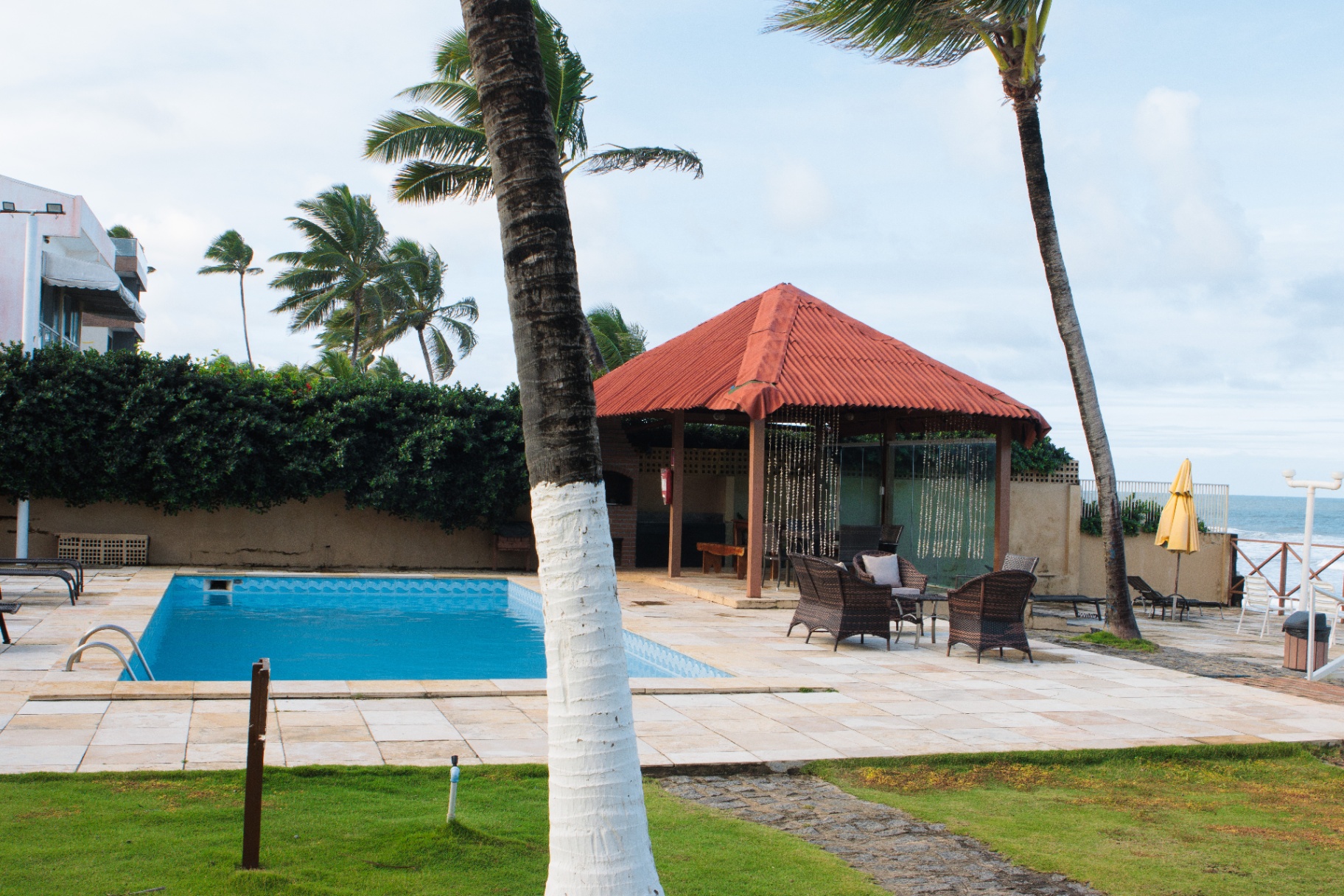Área gourmet com churrasqueira ao lado da piscina